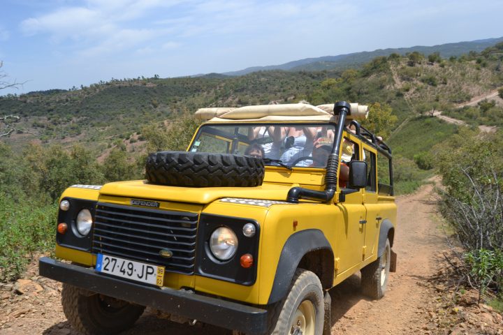 a group of people riding a jeep