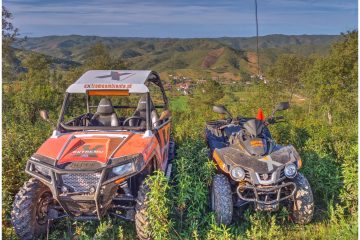 a quad bike and buggy parked on a grassy field