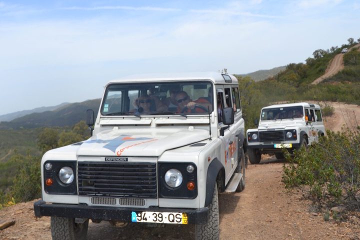 a group of people riding a jeep