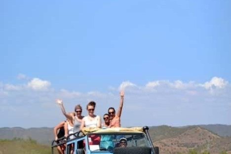 a group of people riding a jeep