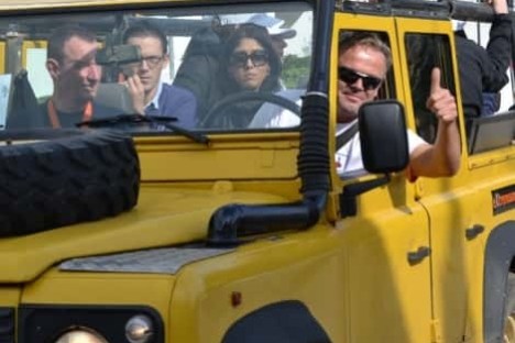 a group of people riding a jeep