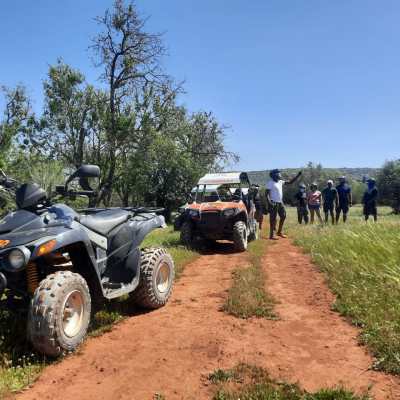 a vehicle is parked on the side of a dirt field