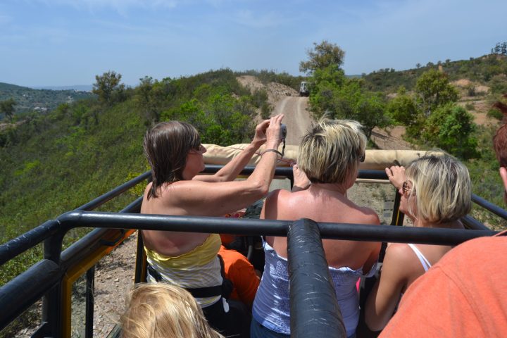 a group of people riding a jeep