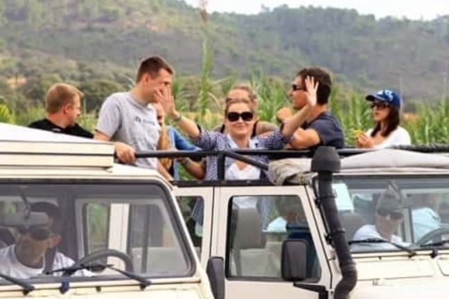 a group of people riding a jeep