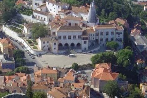 a large building with a mountain in the background