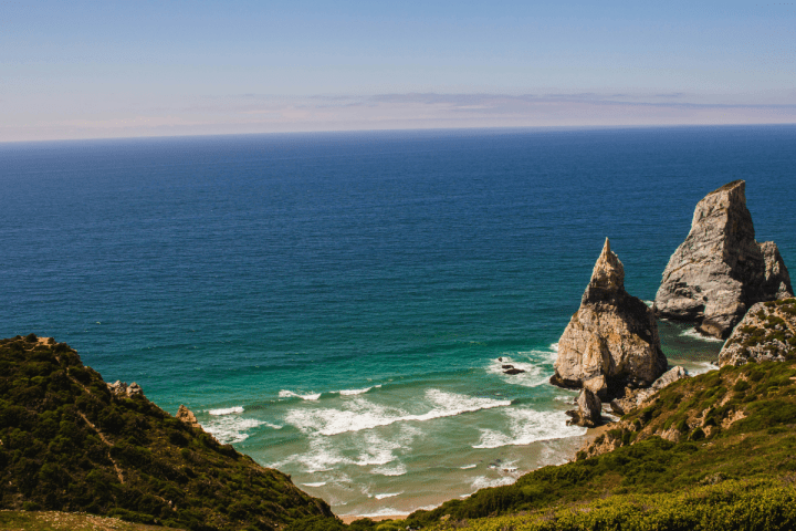 a rocky island in the middle of a body of water