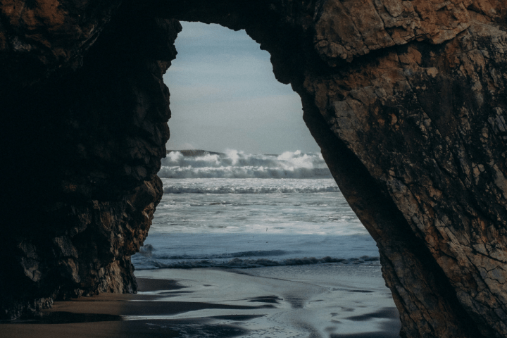 a man standing next to a body of water
