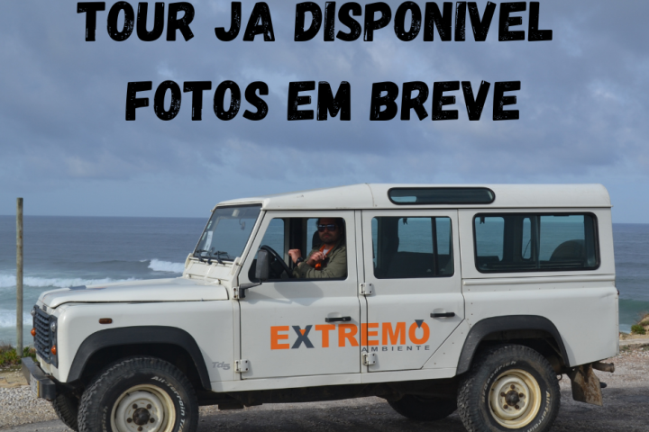 White off-road vehicle labeled 'Extremo' on a coastal road, with text 'Tour já disponível, fotos em breve' above.